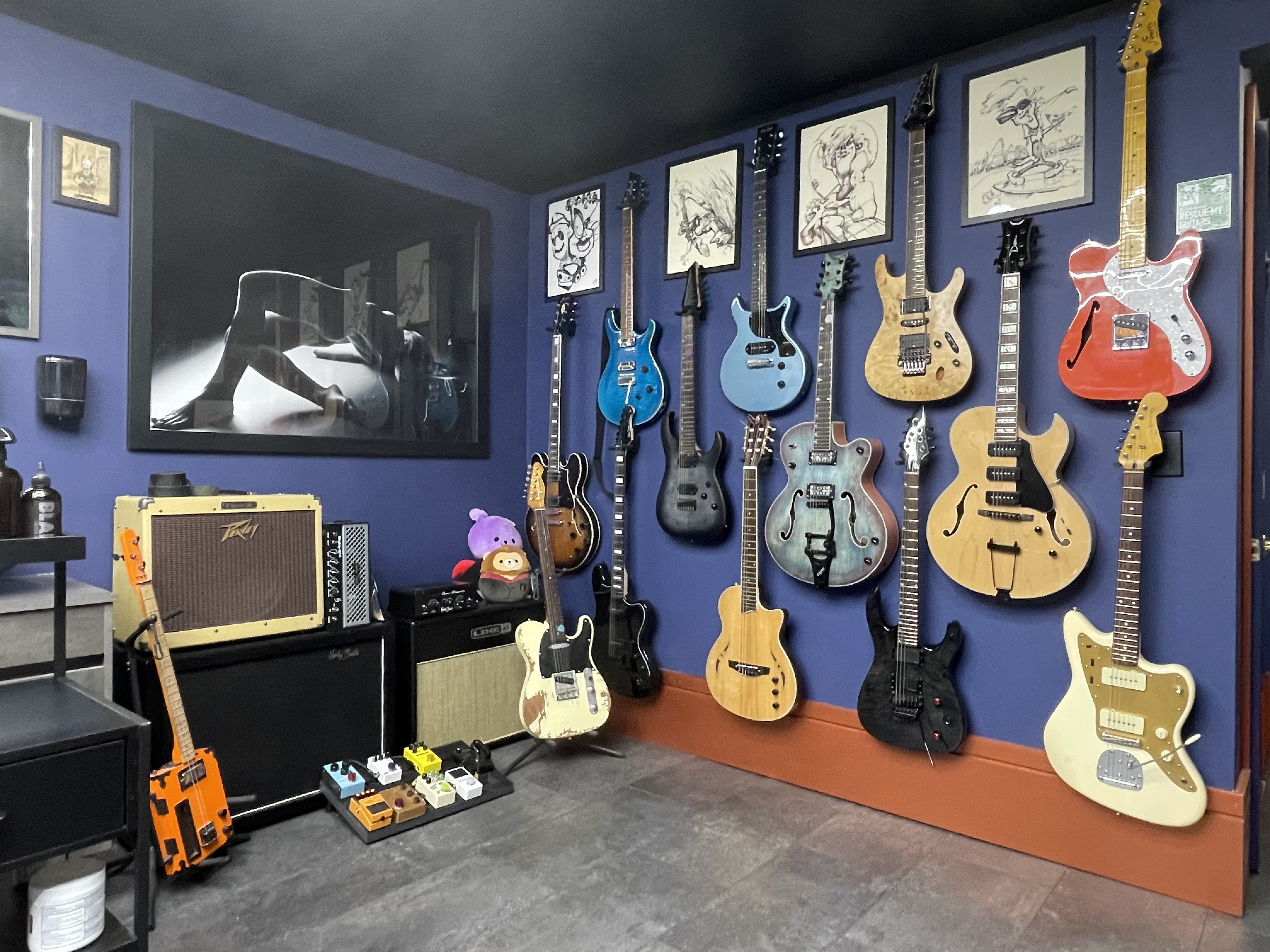 Magic Circle Tattoo Studio Interior - Professional Custom Tattoo Shop in Bay City Michigan with Vintage Guitar Collection Display